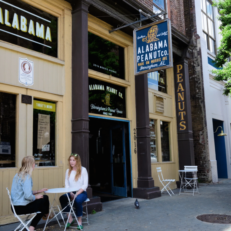 Alabama Peanut Company, Morris Avenue, view of outside of building with people sitting at table in front