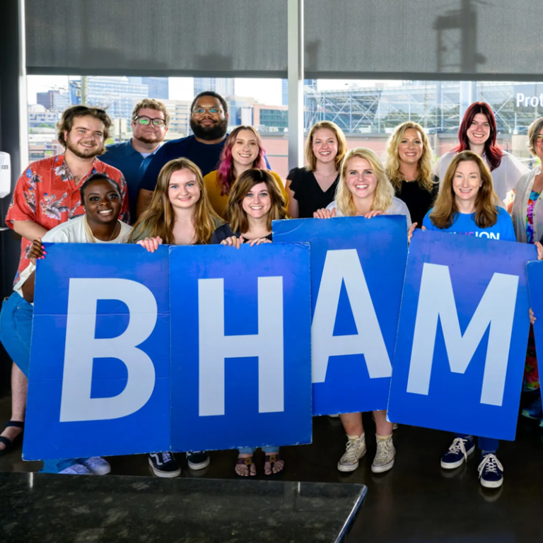 Bham Now, group of employees holding up large blue Bham letters