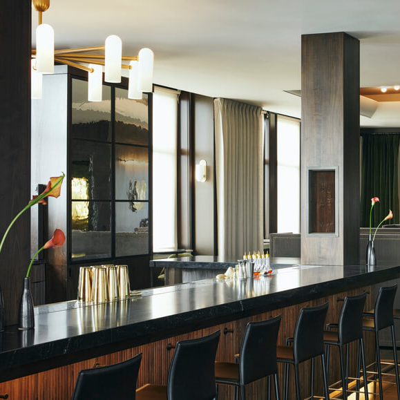 John Hand Club and Hotel, modern minimal bar with black stools and drinks