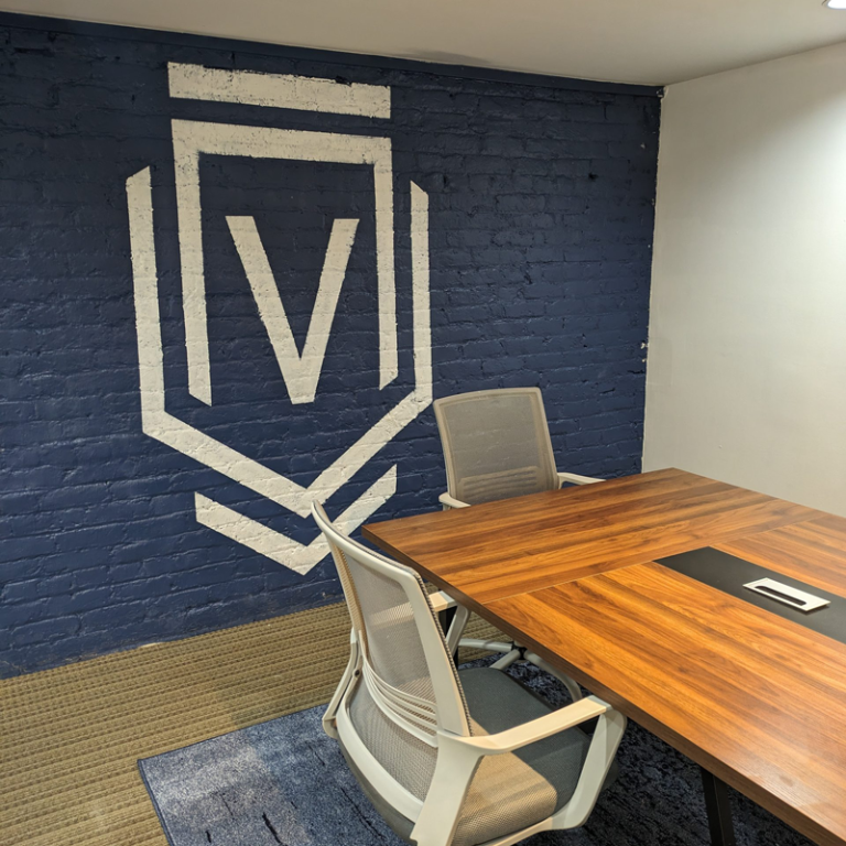 Virtus Law Group office with large logo painted in white on blue wall